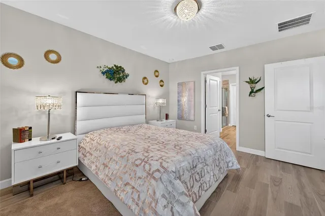 a bedroom with a bed and a chandelier