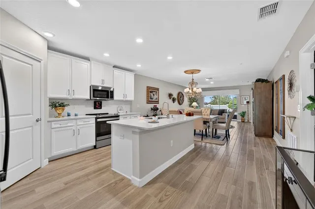 a kitchen with a sink microwave and refrigerator