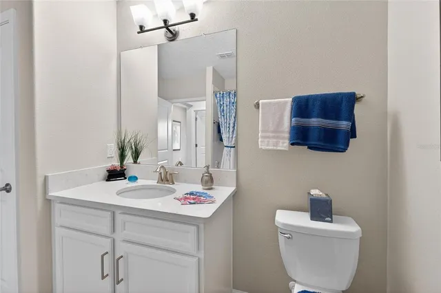 a bathroom with a sink toilet and mirror