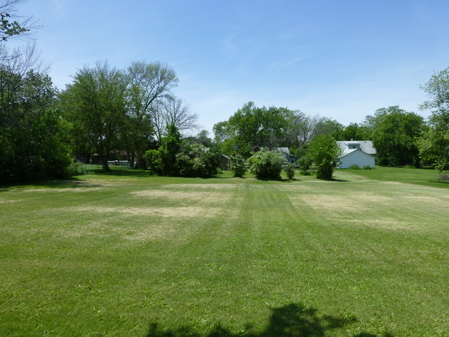 14411 Smith Road Lockport, IL 60441 - Photo 11 of 13 a view of a grassy field with trees in the background