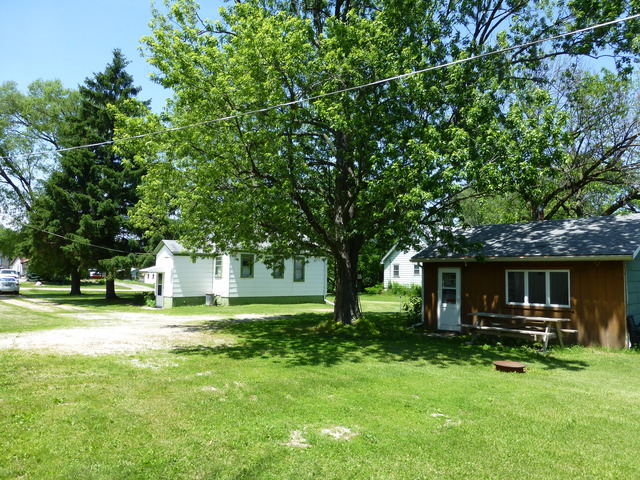 14411 Smith Road Lockport, IL 60441 - Photo 10 of 13 a front view of a house with a yard table and chairs