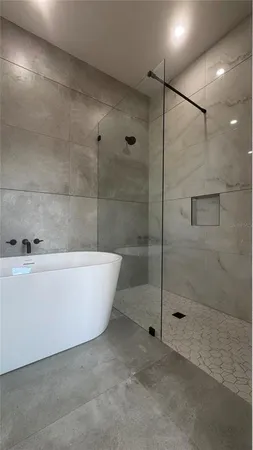 a bathroom with a bathtub and a shower