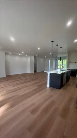 a view of a kitchen with a sink and a stove top oven