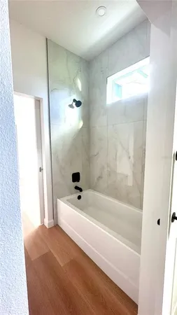 a bathroom with a bathtub and a shower