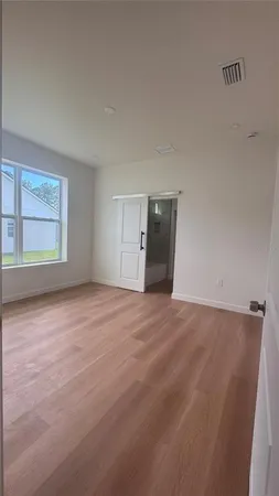 an empty room with windows and closet