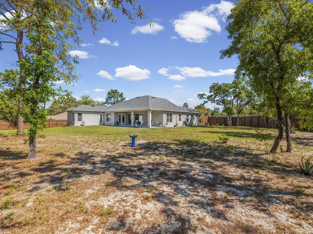 11981 Robina Road Weeki Wachee, FL 34614 - Photo 57 of 93 a front view of a house with a yard