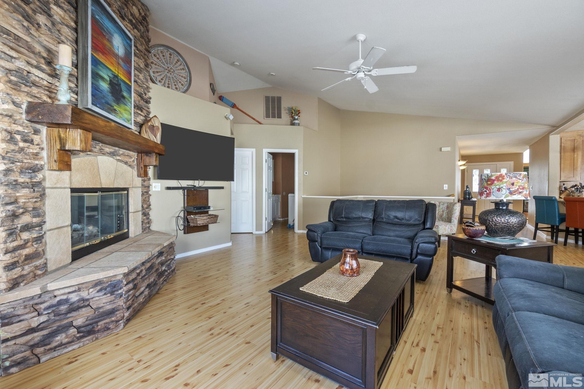 6075 Sunrise Meadows Loop Reno, NV 89519 - Photo 11 of 38 a living room with furniture and a fireplace