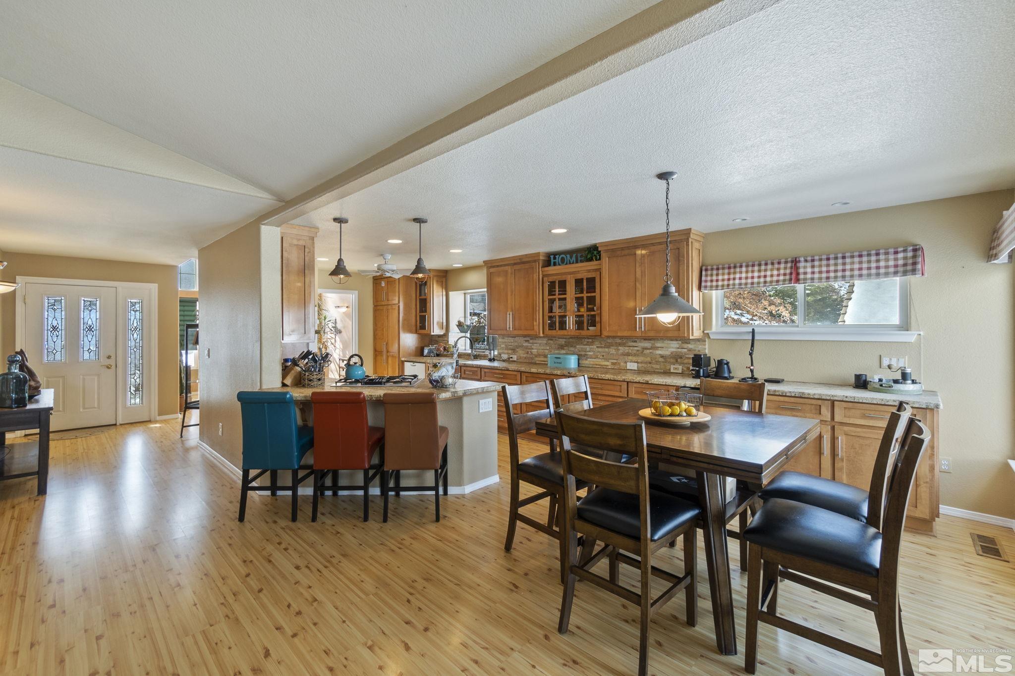 6075 Sunrise Meadows Loop Reno, NV 89519 - Photo 15 of 38 a view of a dining room with furniture and wooden floor