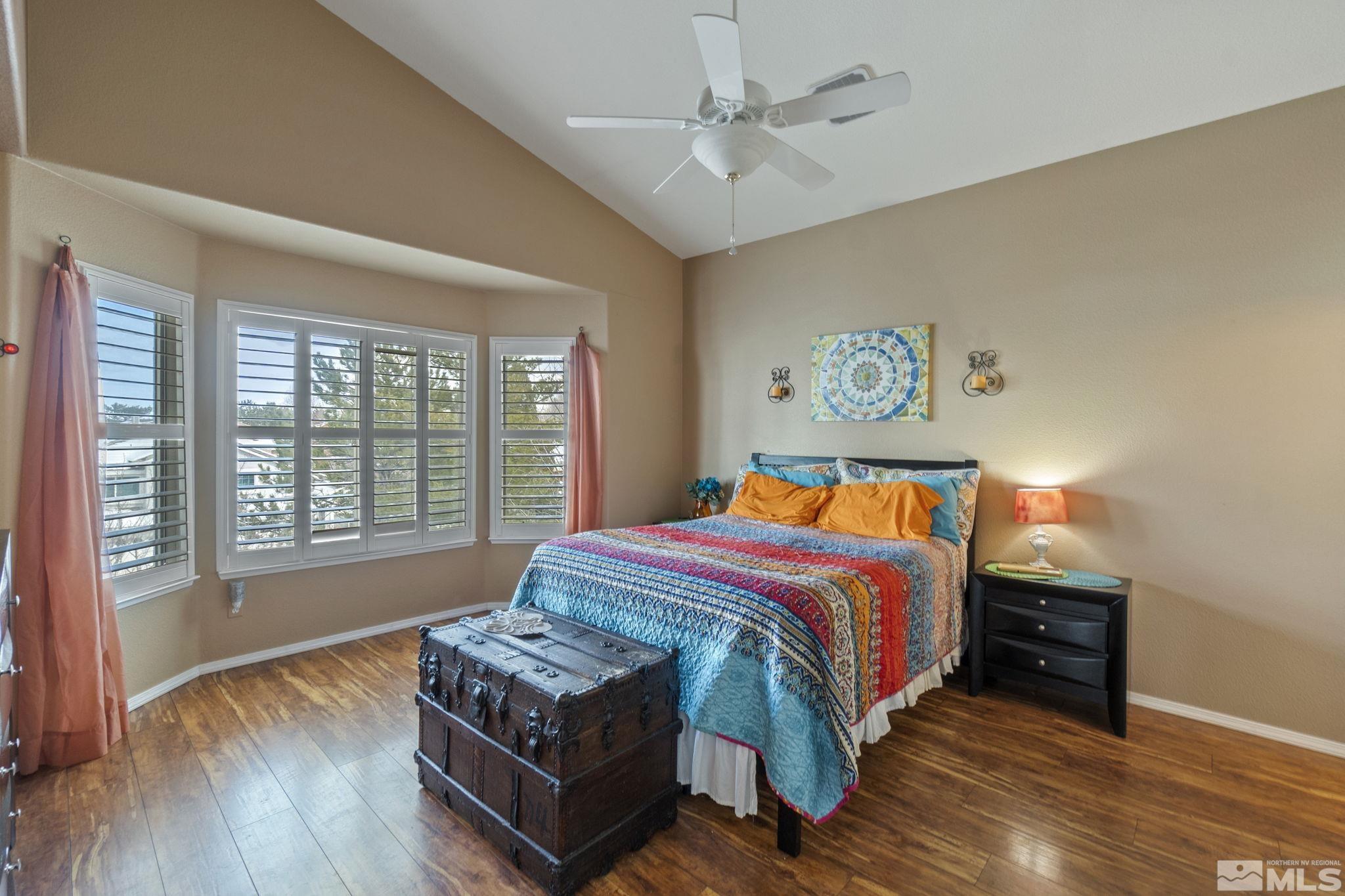 6075 Sunrise Meadows Loop Reno, NV 89519 - Photo 16 of 38 a bed sitting in a bedroom next to a window