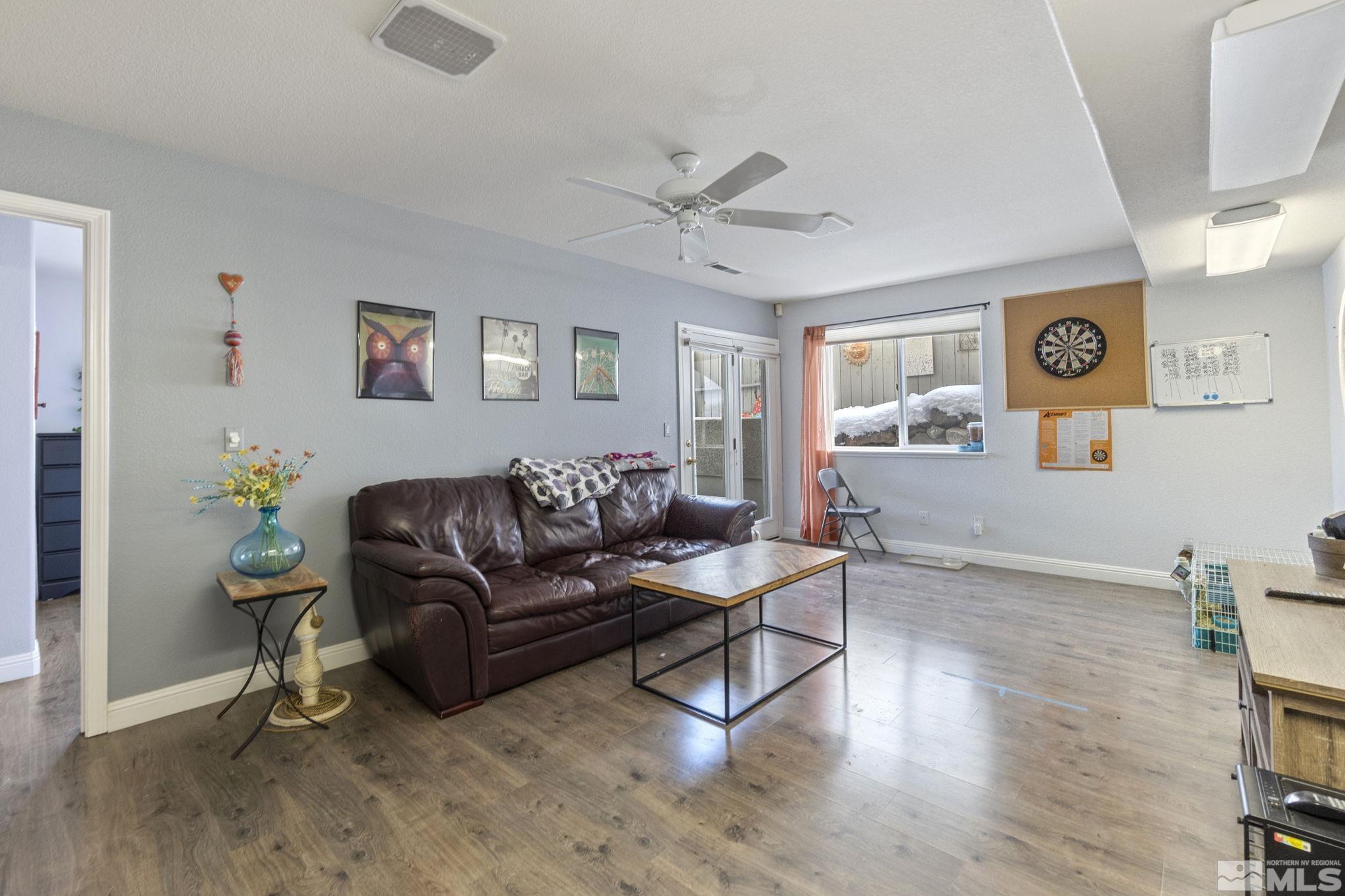 6075 Sunrise Meadows Loop Reno, NV 89519 - Photo 19 of 38 a living room with furniture and a wooden floor