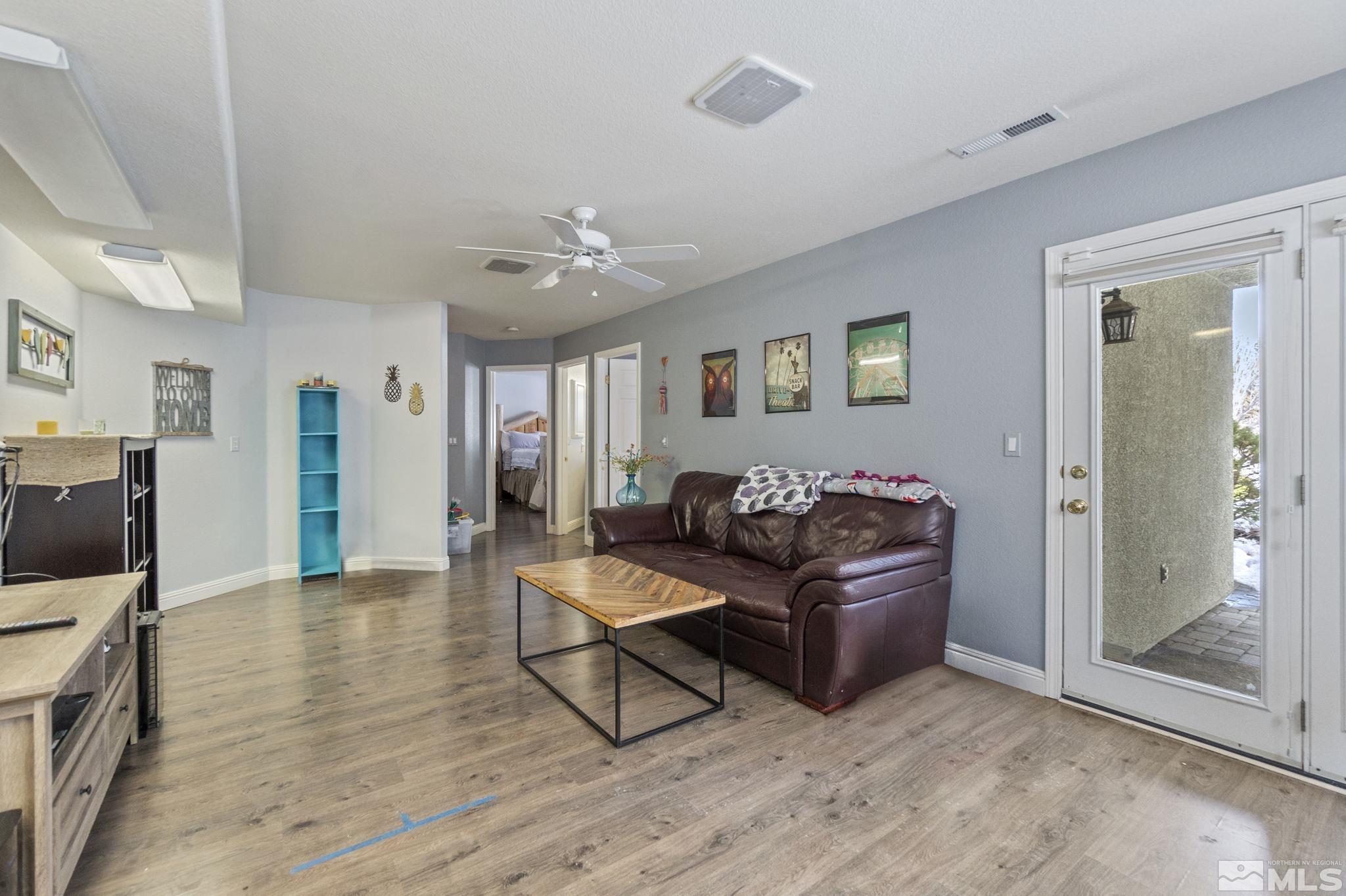 6075 Sunrise Meadows Loop Reno, NV 89519 - Photo 20 of 38 a living room with furniture and a wooden floor
