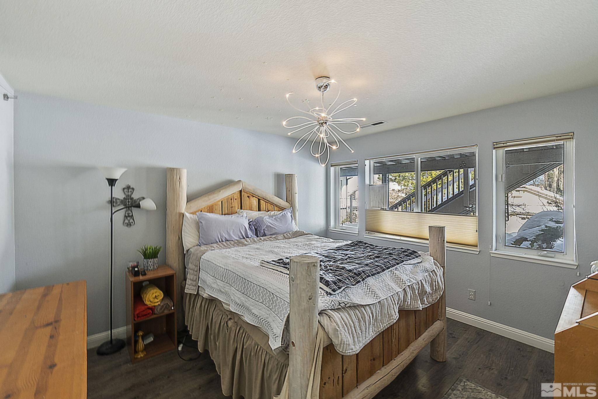 6075 Sunrise Meadows Loop Reno, NV 89519 - Photo 21 of 38 a bedroom with a bed and wooden floor