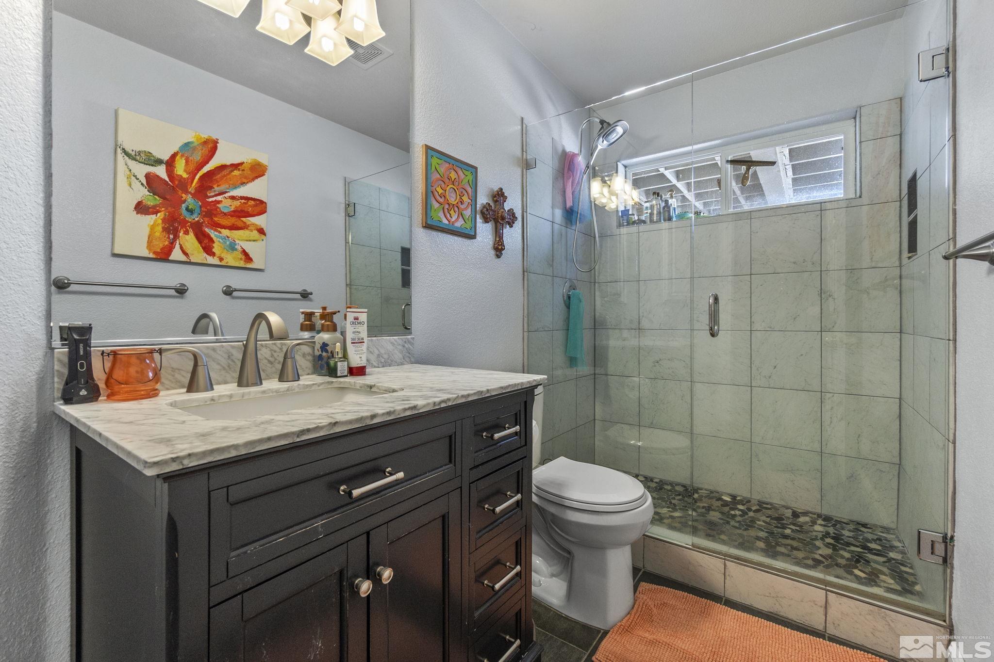 6075 Sunrise Meadows Loop Reno, NV 89519 - Photo 23 of 38 a bathroom with a sink a toilet and shower
