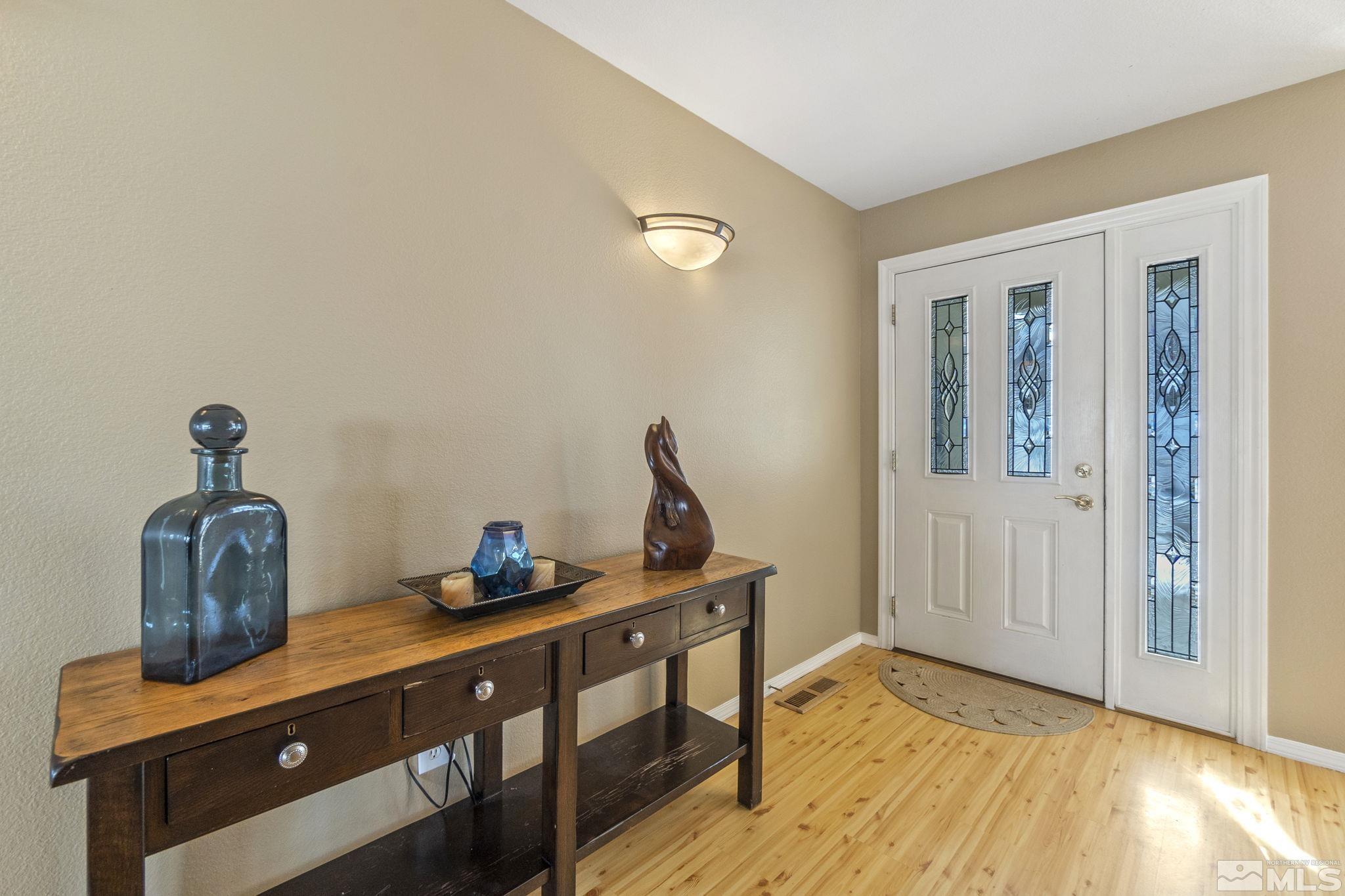 6075 Sunrise Meadows Loop Reno, NV 89519 - Photo 3 of 38 a view of room with furniture and wooden floor