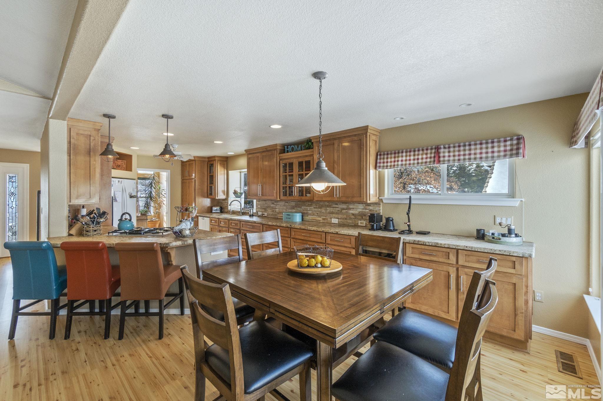 6075 Sunrise Meadows Loop Reno, NV 89519 - Photo 35 of 38 a view of a dining room with furniture window and wooden floor