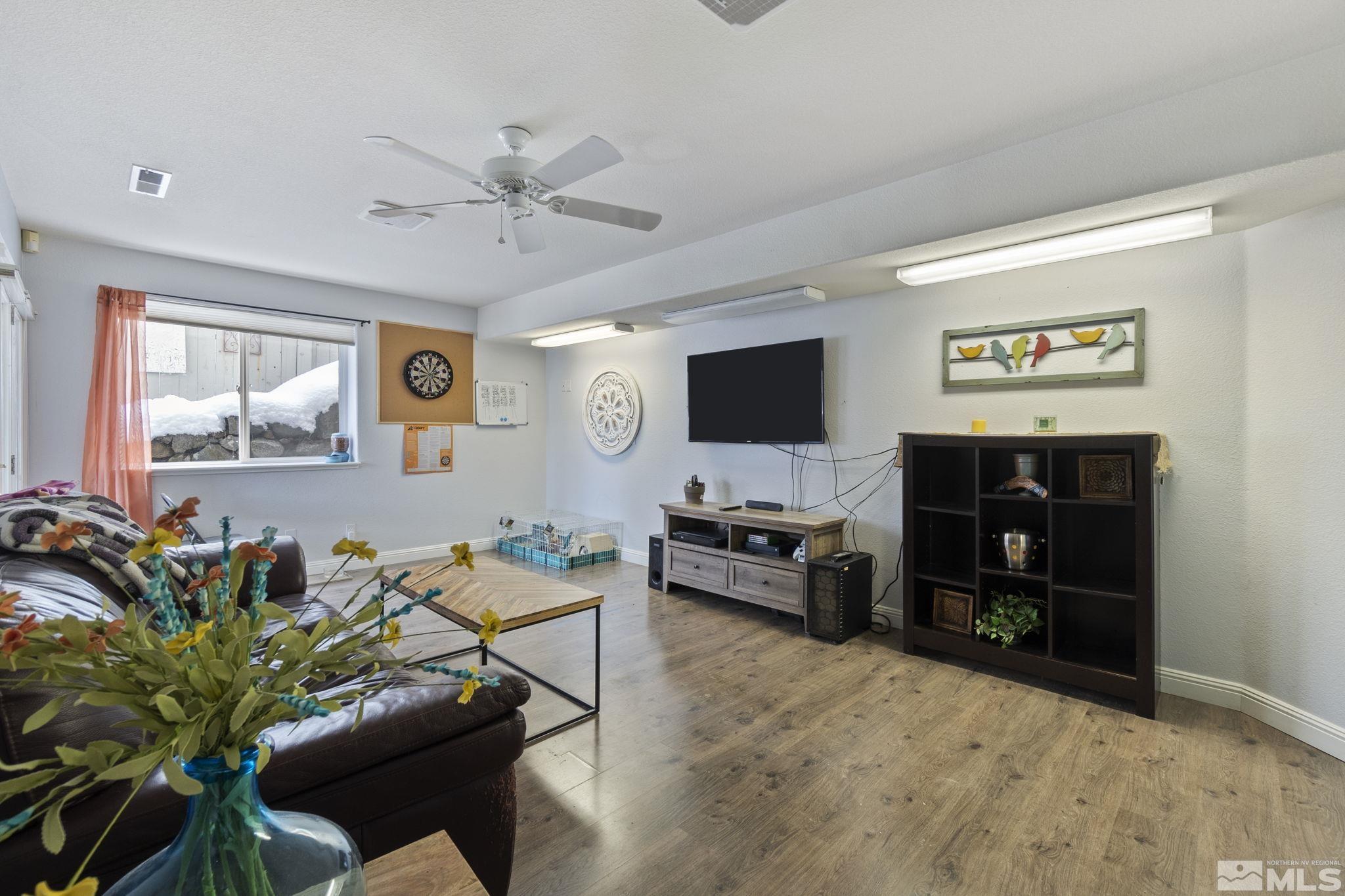6075 Sunrise Meadows Loop Reno, NV 89519 - Photo 36 of 38 a living room with furniture and a flat screen tv