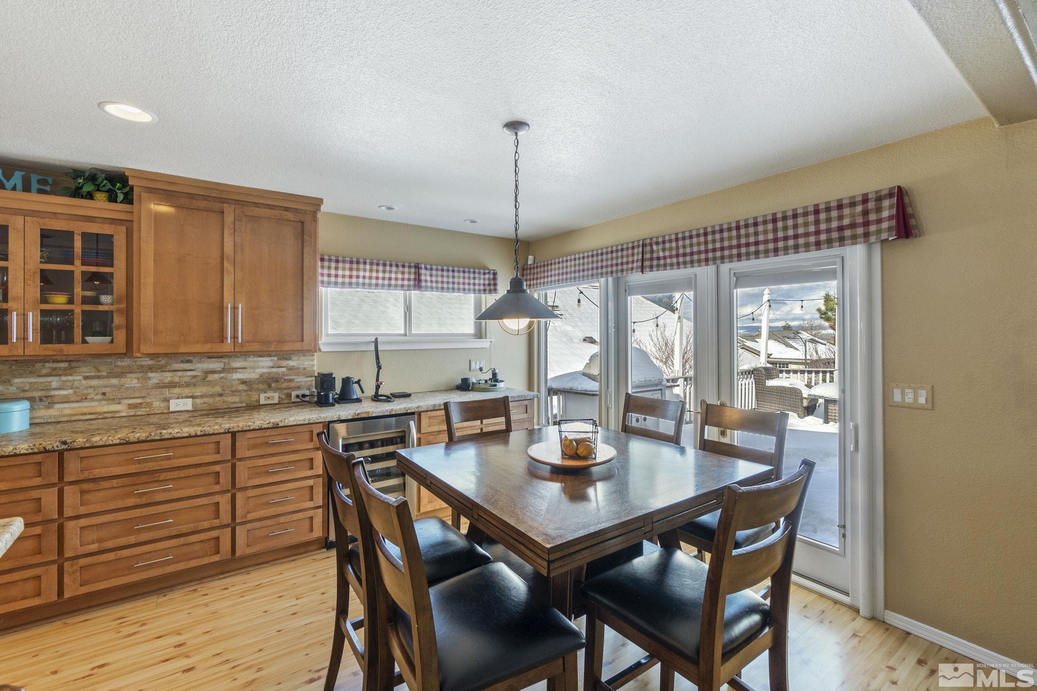 6075 Sunrise Meadows Loop Reno, NV 89519 - Photo 38 of 38 a view of a dining room with furniture window and wooden floor