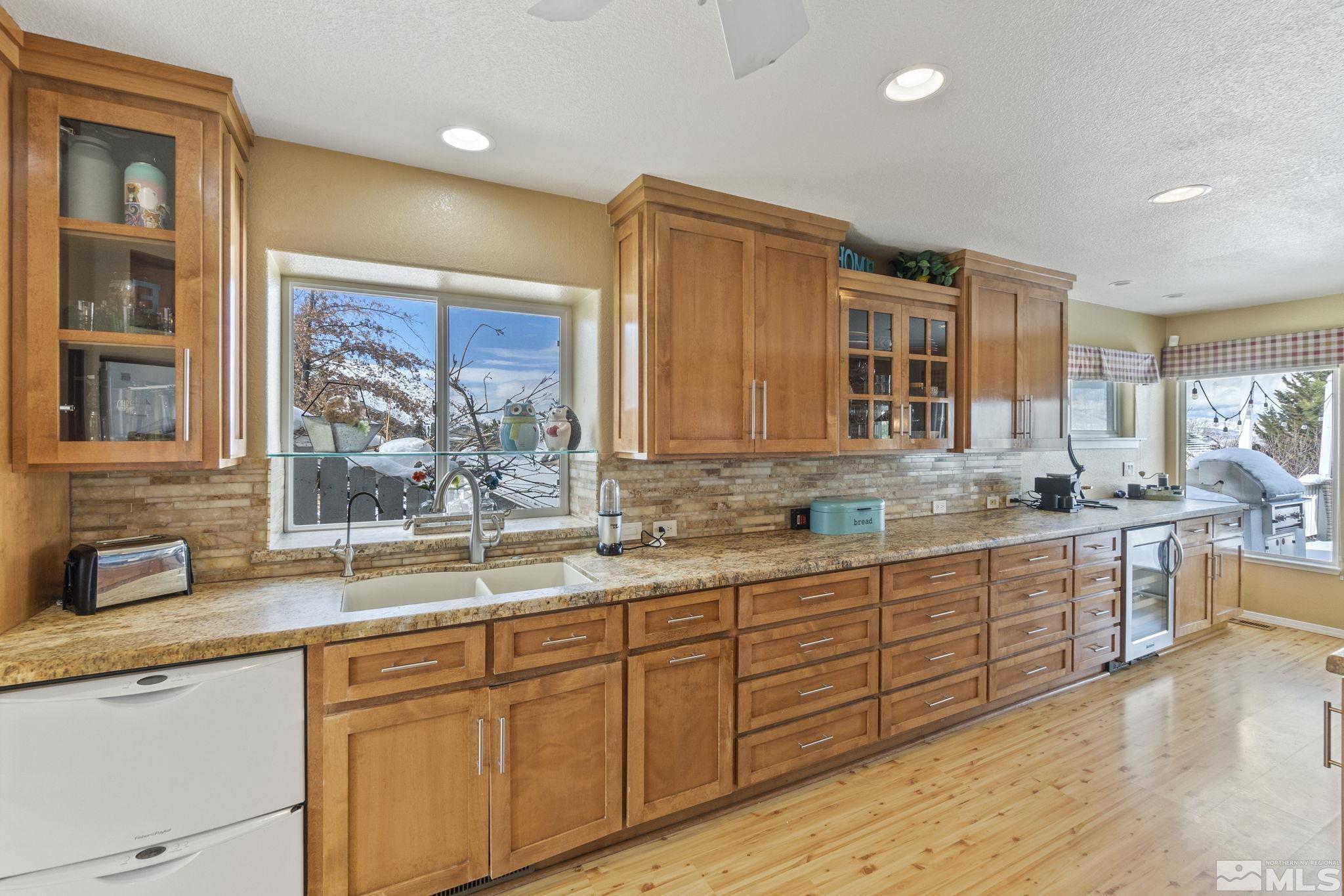 6075 Sunrise Meadows Loop Reno, NV 89519 - Photo 6 of 38 a kitchen with lots of counter top space and wooden floor