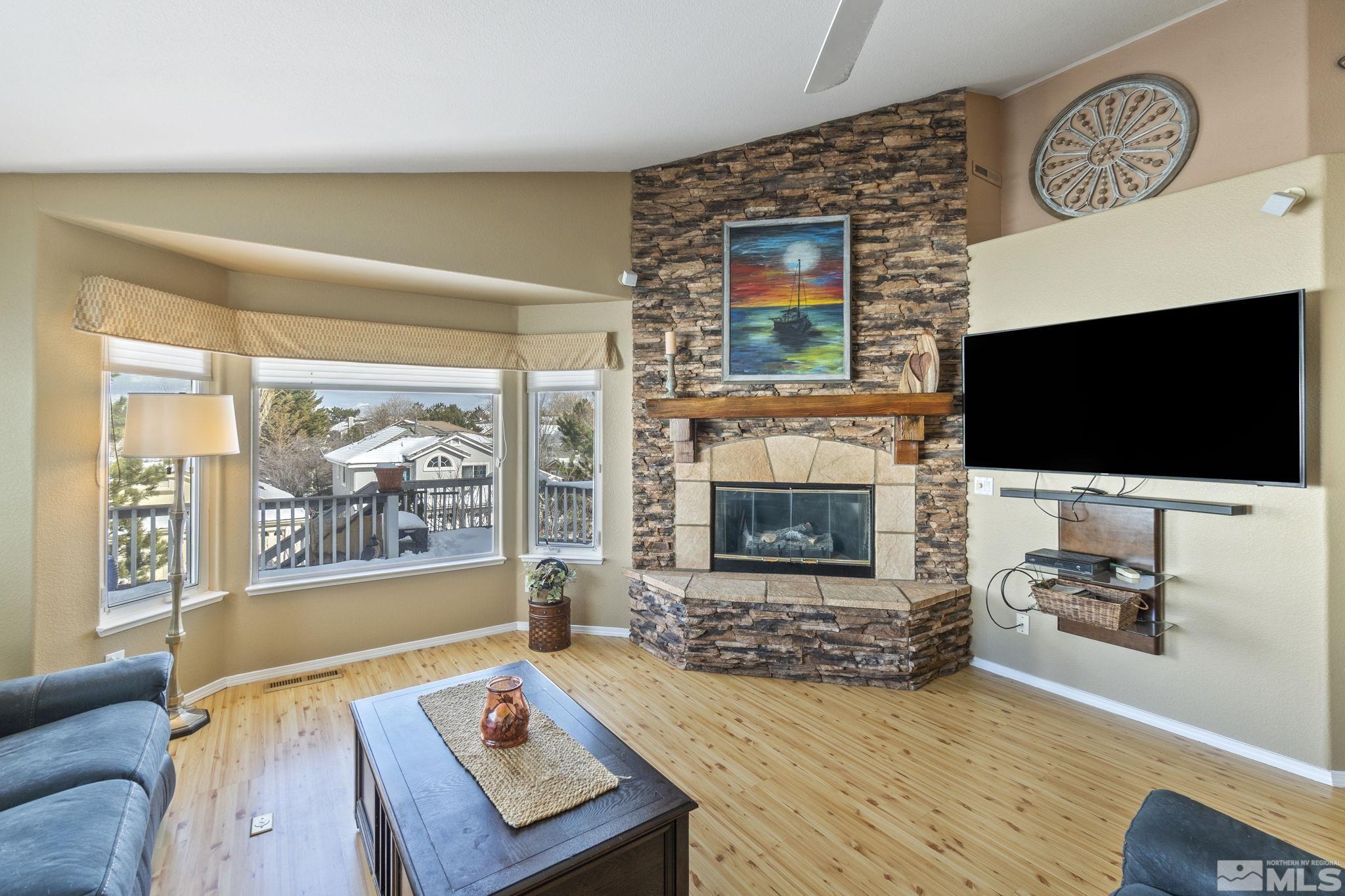 6075 Sunrise Meadows Loop Reno, NV 89519 - Photo 10 of 38 a living room with fireplace furniture and a flat screen tv