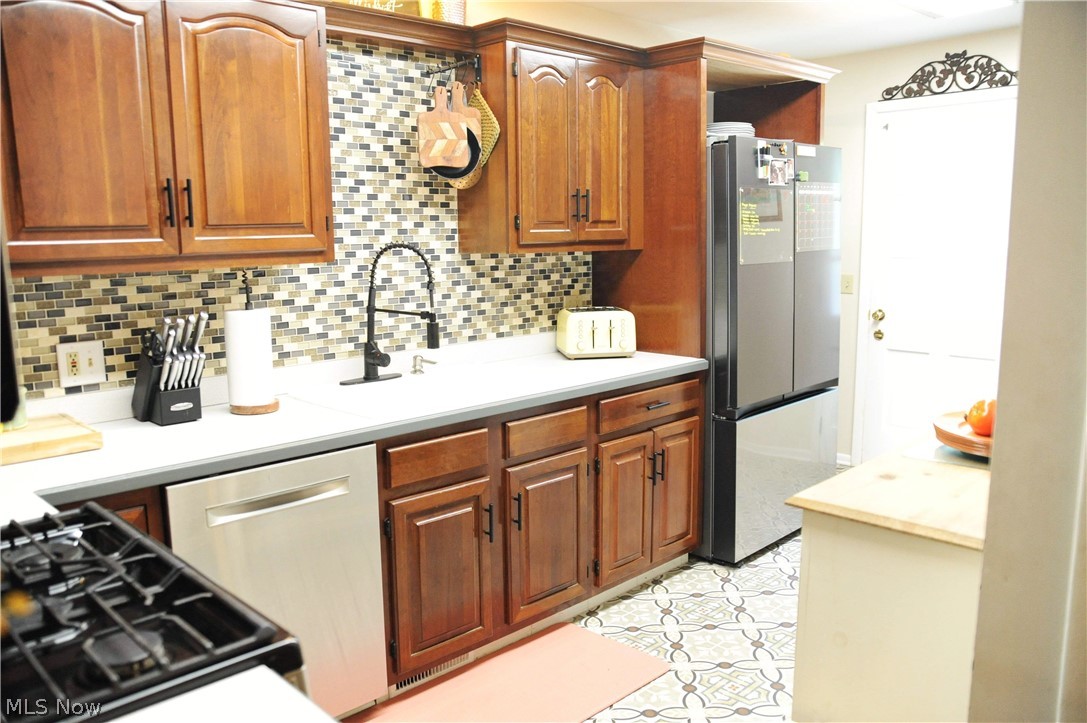 5804 Hills And Dales Road Northwest Canton, OH 44708 - Photo 16 of 28 Kitchen with appliances and cherry cabinets