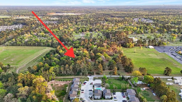 an aerial view of a city with lots of residential buildings ocean and mountain view in back