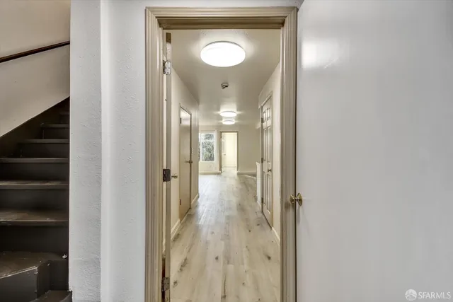 a view of a kitchen area with furniture and wooden floor