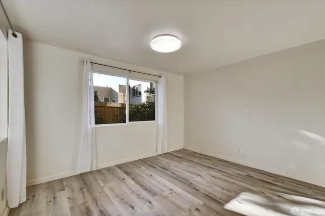 a living room with furniture and a painting on the wall