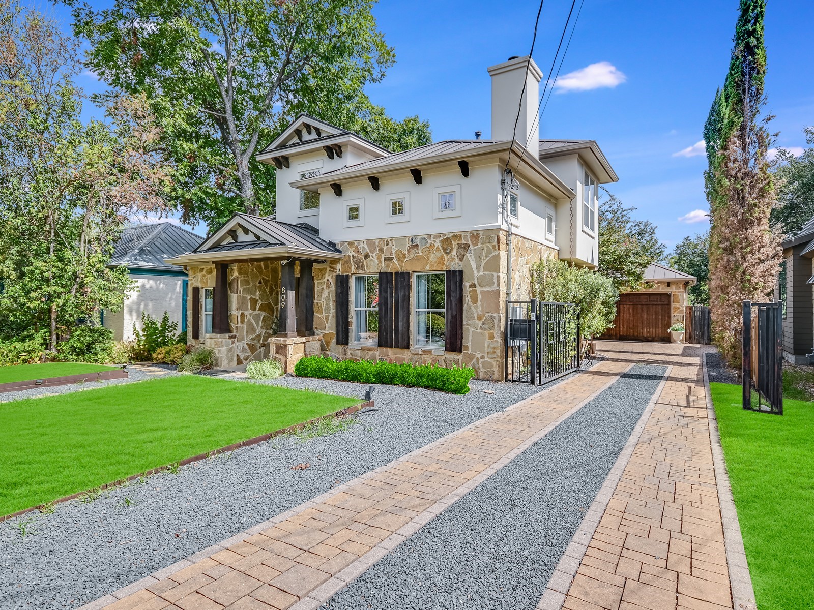 809 Kinney Avenue Austin, TX 78704 - Photo 2 of 21 a front view of a house with a yard and garage