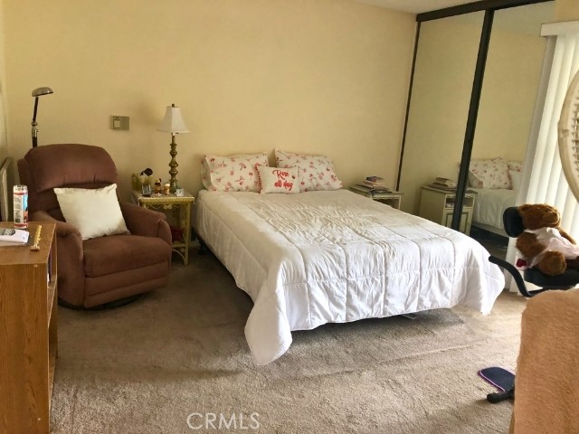 200 East Racquet Club Road, Unit 19 Palm Springs, CA 92262 - Photo 8 of 21 a bedroom with a bed and a couch
