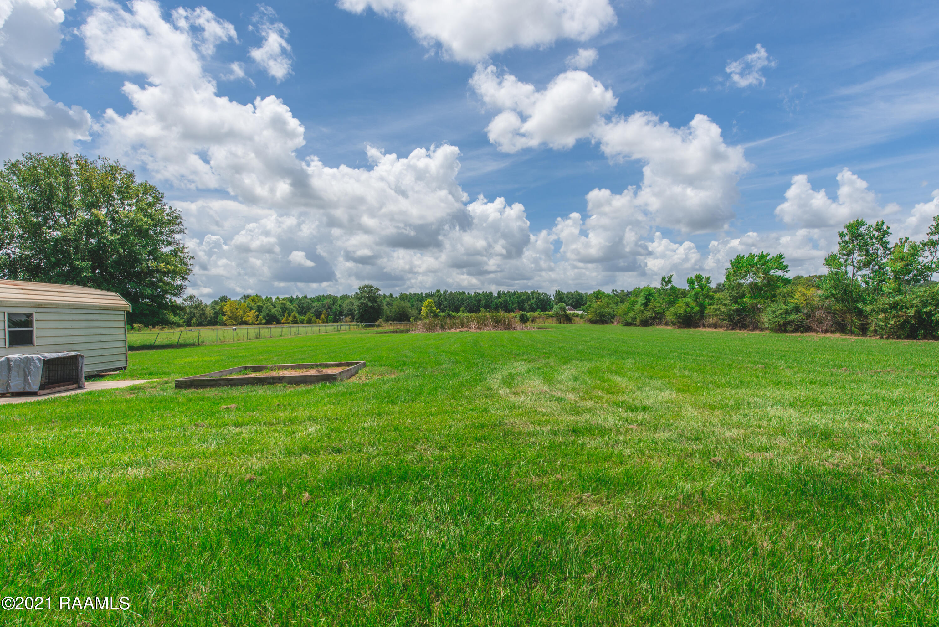 254 Lenora Road Church Point, LA 70525 - Photo 28 of 34 Spacious yard with pond in the back