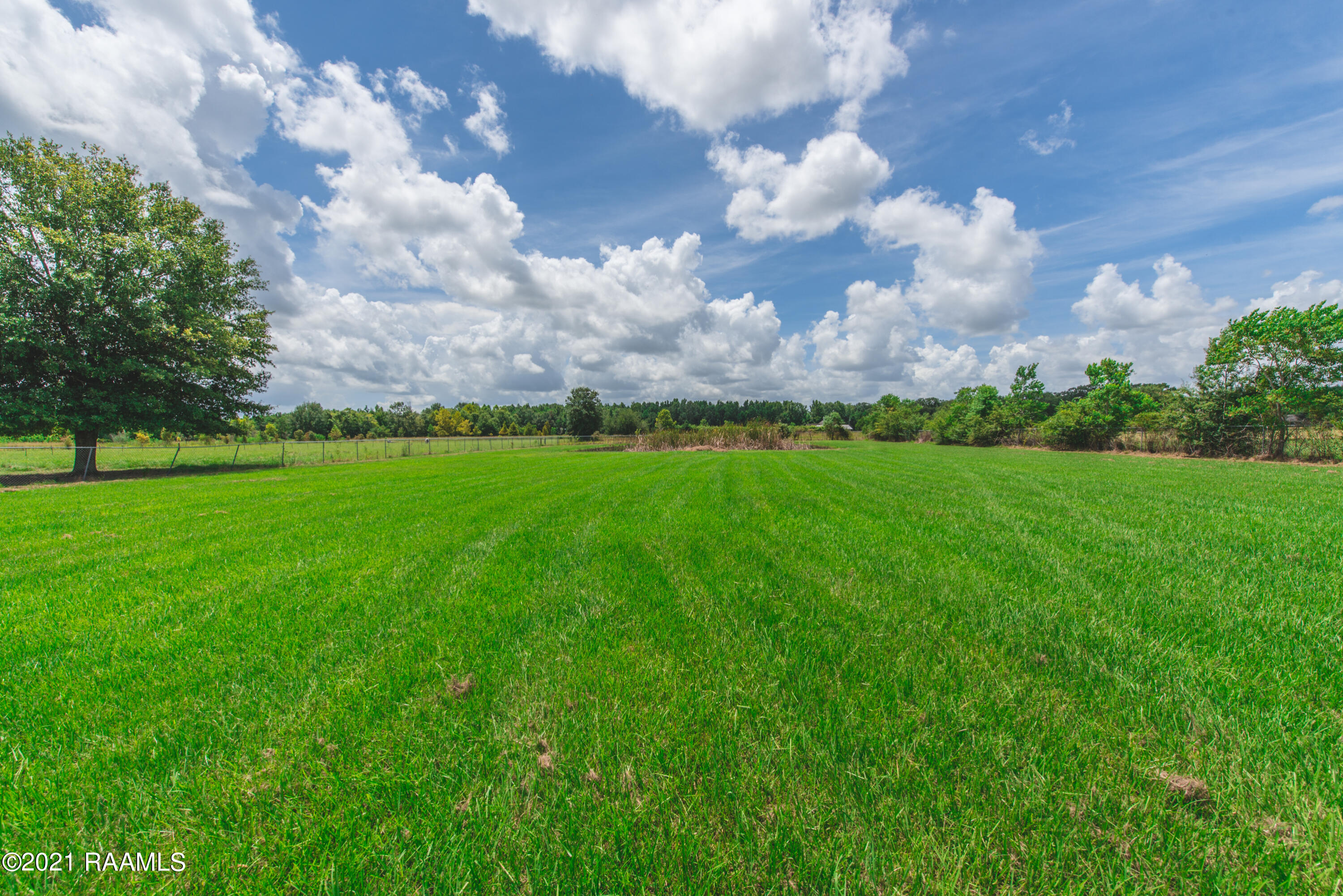 254 Lenora Road Church Point, LA 70525 - Photo 29 of 34 Spacious yard with pond in the back