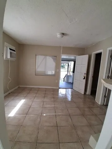 a view of a hallway to rooms and wooden floor