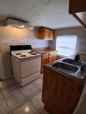 a view of a hallway to rooms and wooden floor
