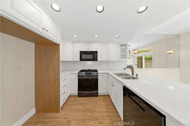 a kitchen with a sink a stove and cabinets