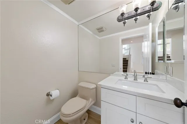 a bathroom with a sink a toilet and mirror