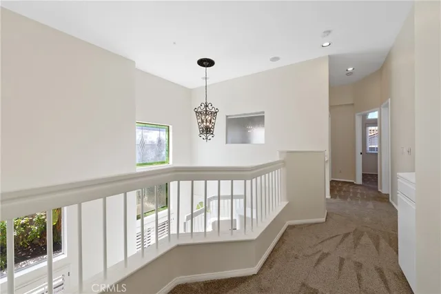 a view of hallway with chandelier