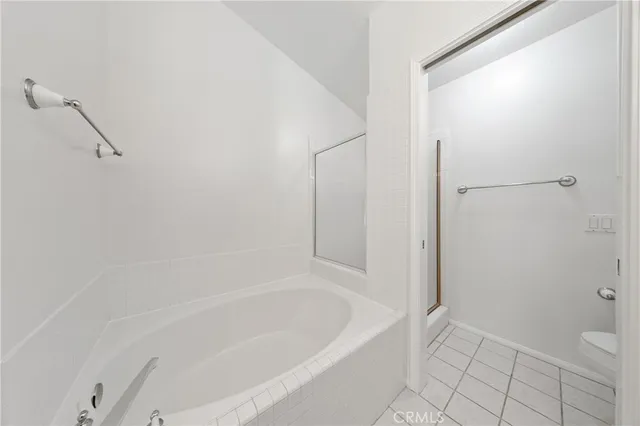 a white bath tub sitting next to a toilet