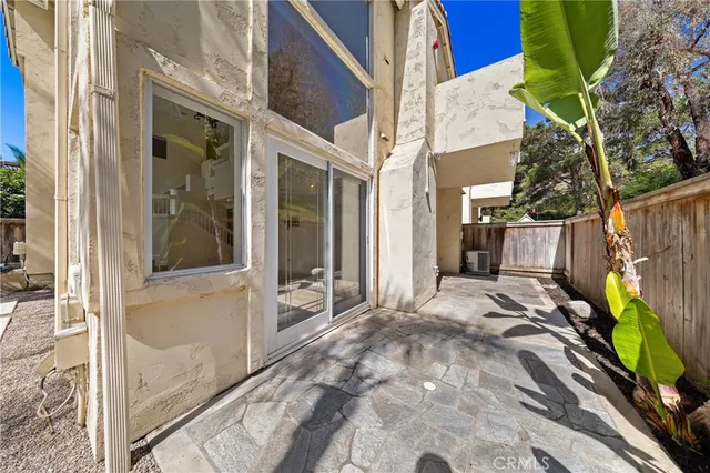 a view of a house with a large window and yard