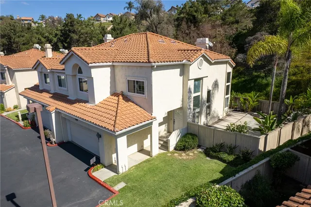 an aerial view of a house with a yard