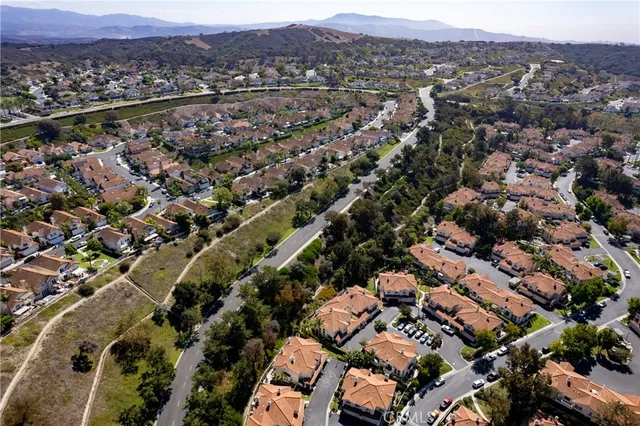 an aerial view of a city and mountain view in back