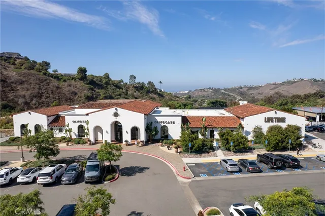 an aerial view of a house with a mountain