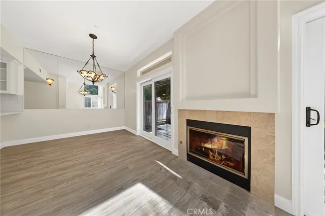 a living room with a fireplace with wooden floor