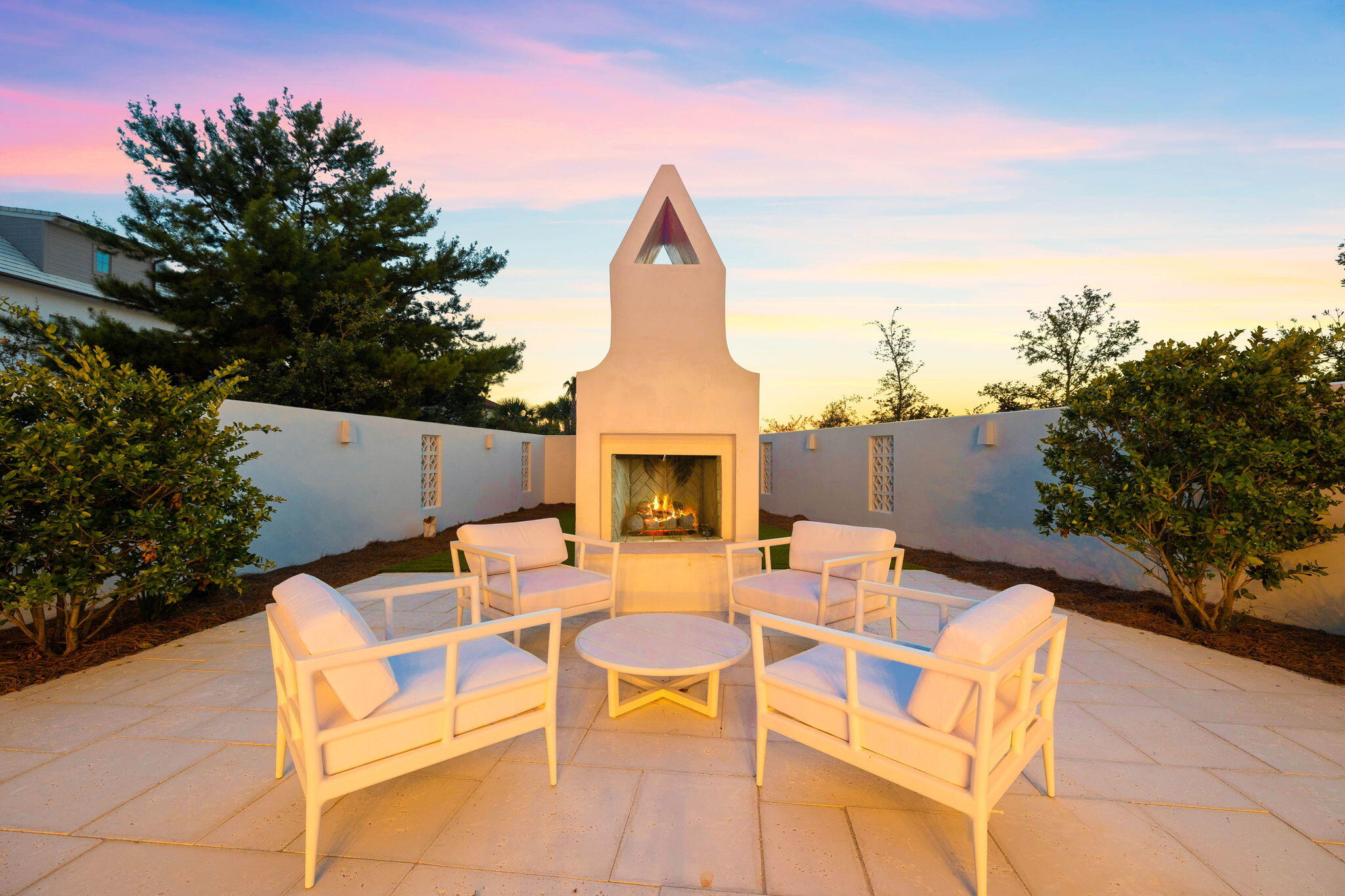 48 Paradise By The Sea Boulevard Inlet Beach, FL 32461 - Photo 9 of 97 a view of a patio with a table and chairs under an umbrella with potted plants