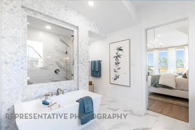 a en suite bathroom with a tub sink and mirror