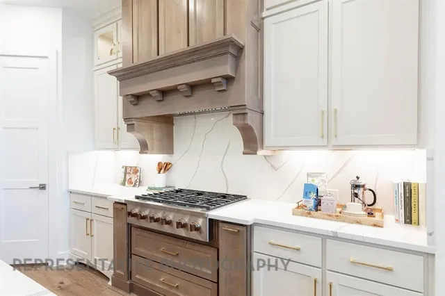 a kitchen with stainless steel appliances granite countertop a sink stove and cabinets