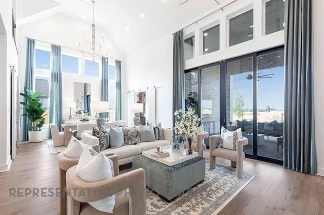 a living room with furniture wooden floor and a chandelier