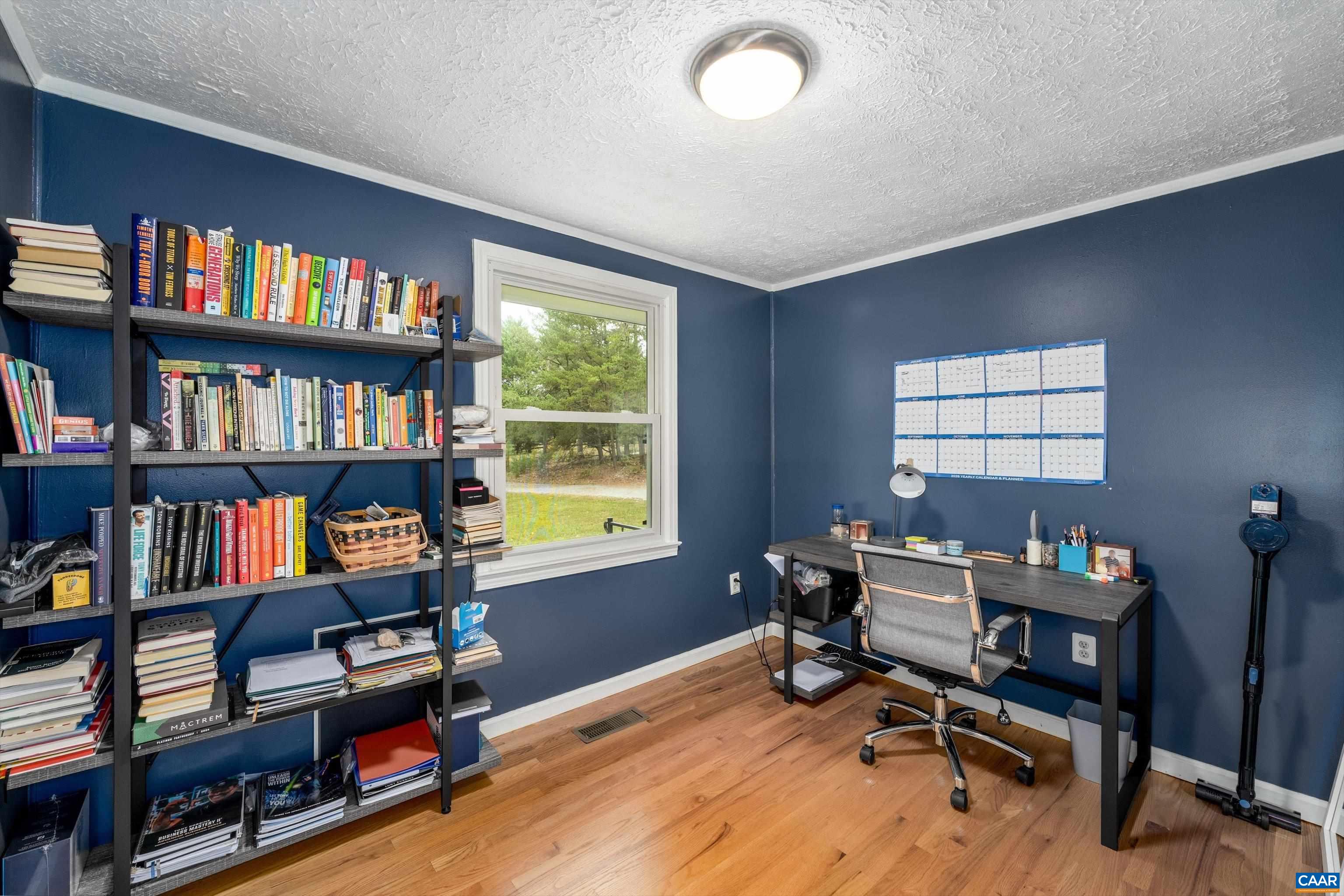 2833 Milton Road Charlottesville, VA 22902 - Photo 24 of 44 a view of a workspace with a bookshelf and a workspace