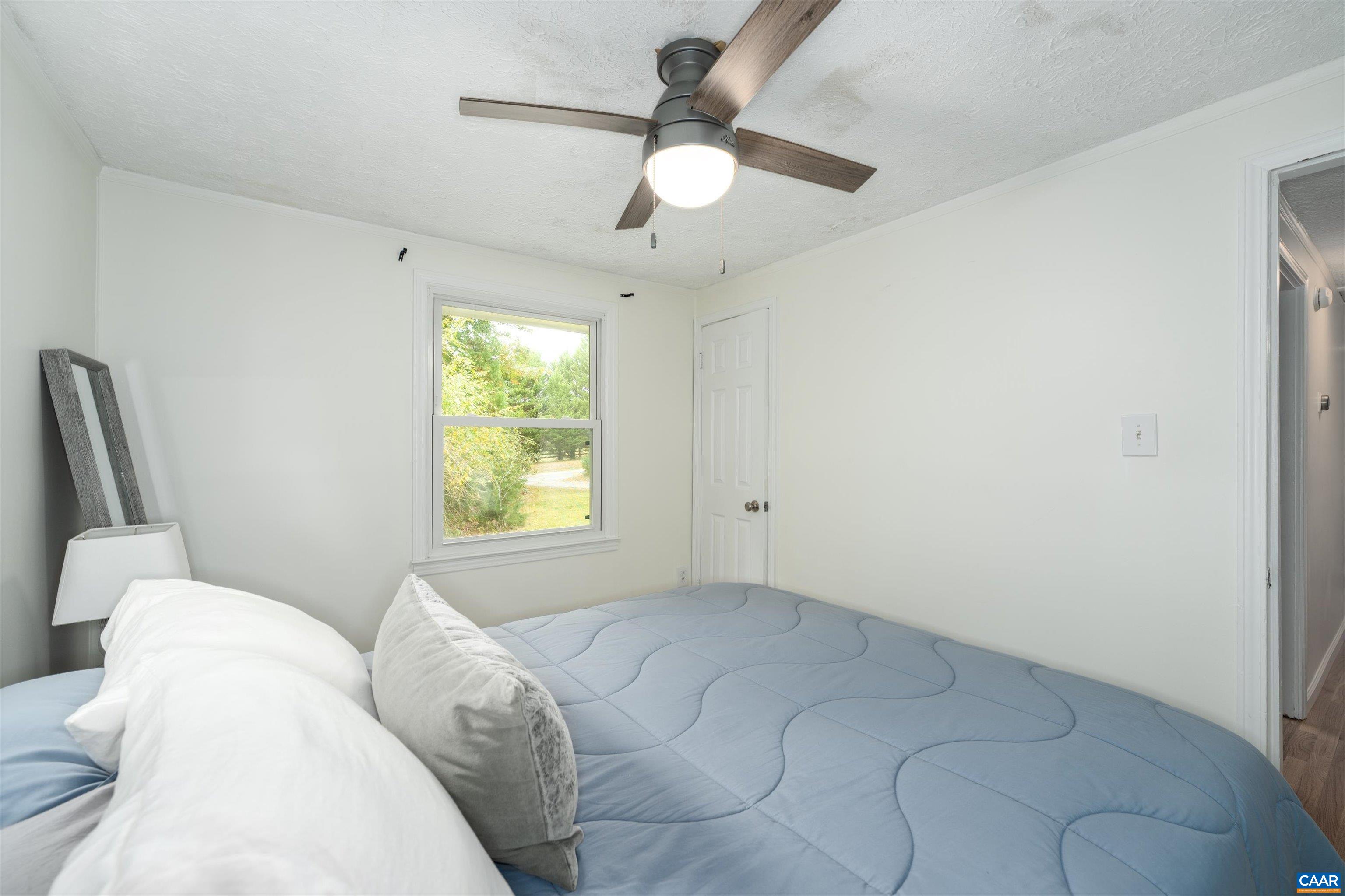 2833 Milton Road Charlottesville, VA 22902 - Photo 28 of 44 a bedroom with a bed and a chandelier