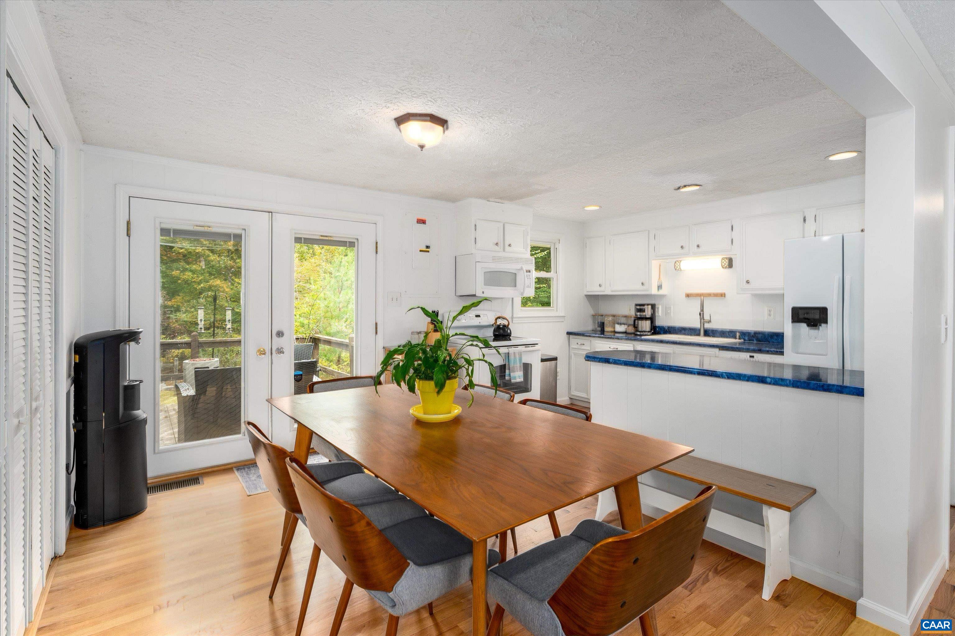 2833 Milton Road Charlottesville, VA 22902 - Photo 6 of 44 a kitchen with a dining table chairs and refrigerator