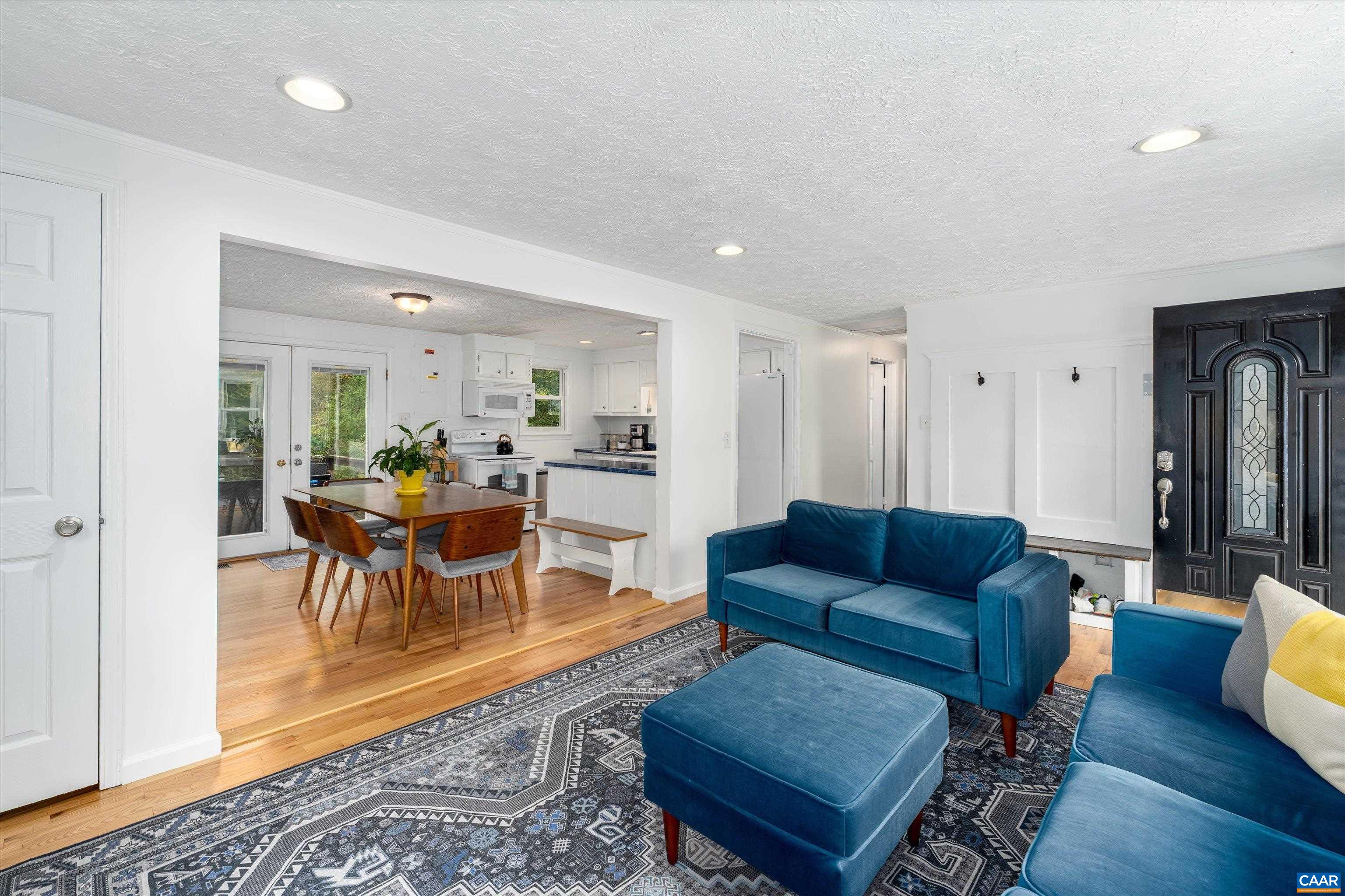2833 Milton Road Charlottesville, VA 22902 - Photo 8 of 44 a living room with furniture a wooden floor and dining table
